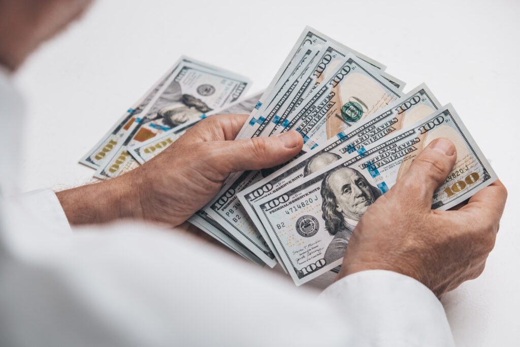 man is counting cash. close-up of hands holding paper cash US dollars.