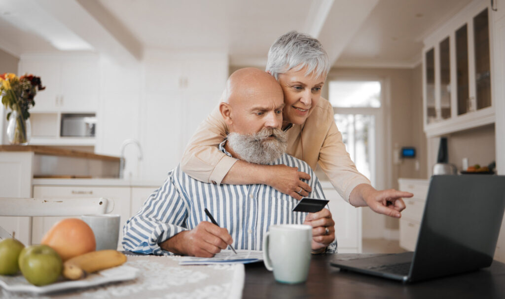 Home, credit card and senior couple with a laptop, connection or budget planning with retirement, i
