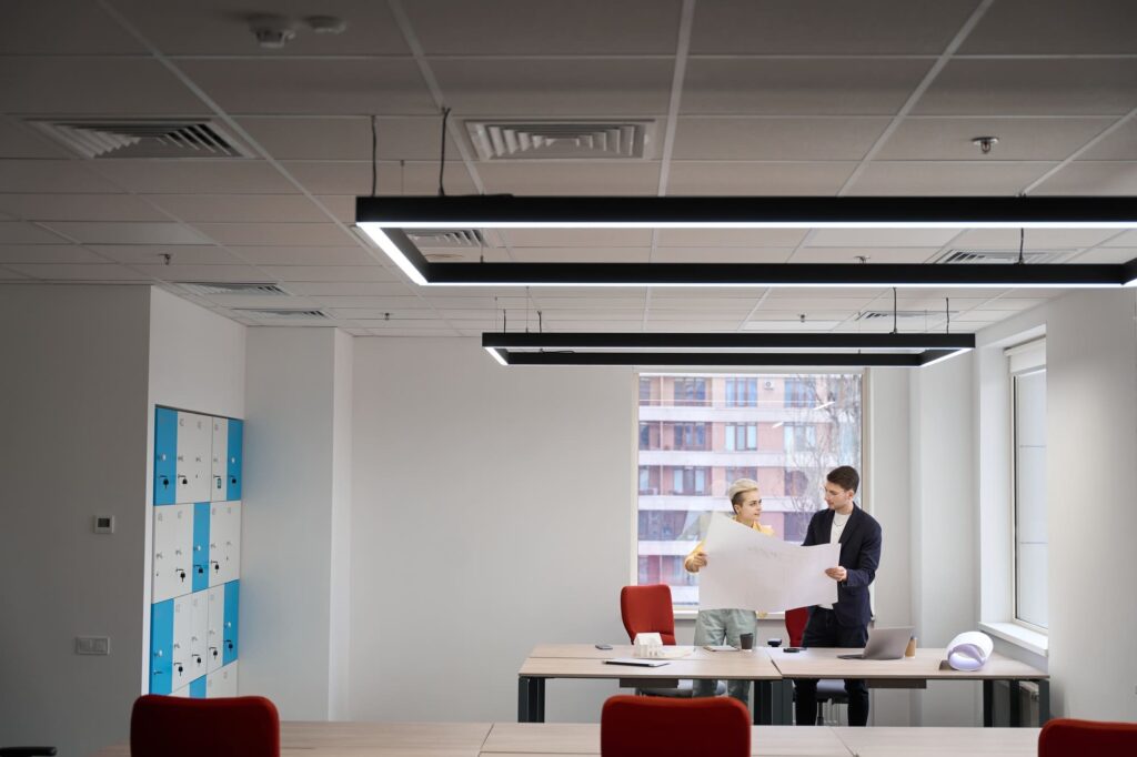 Interior designers studying building drawing in the office