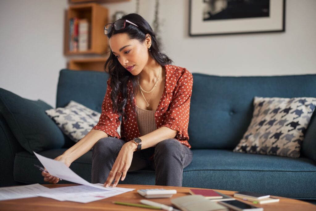 Woman reading bills at home