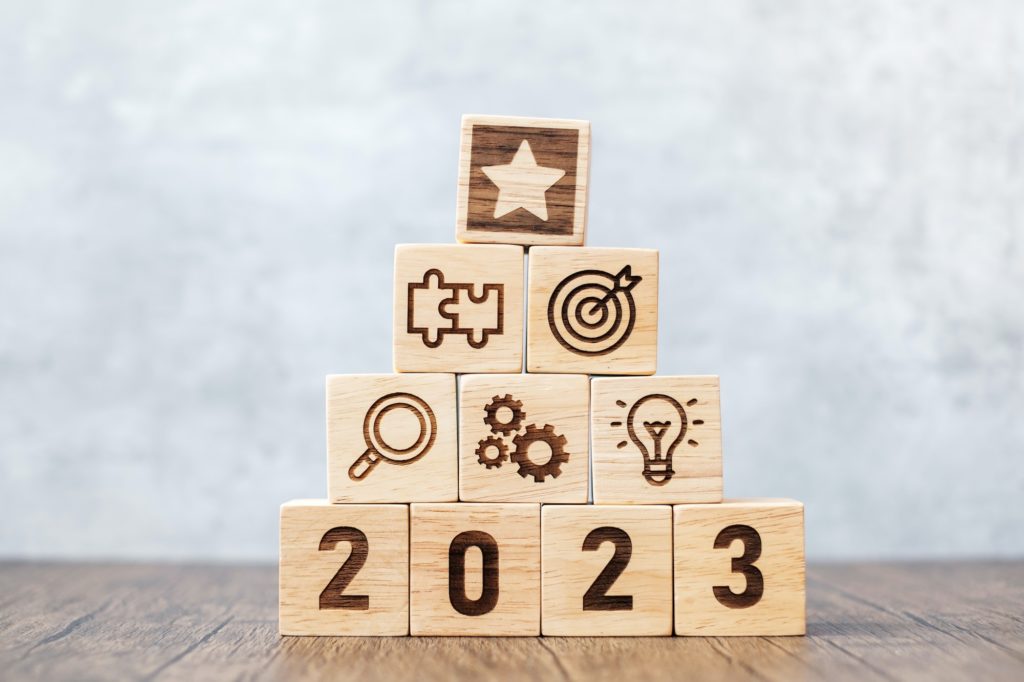 2023 wood block with mission, action, objective, teamwork, plan, idea and New Year start concept