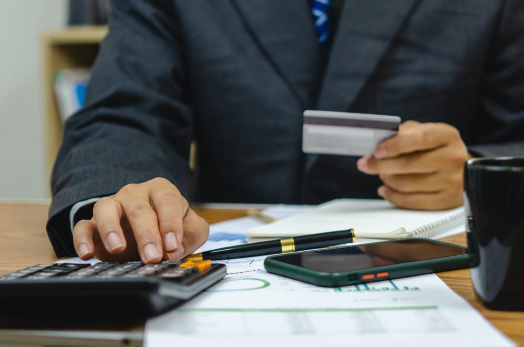 employee of a company paying a charge with a credit card while conducting internet shopping.