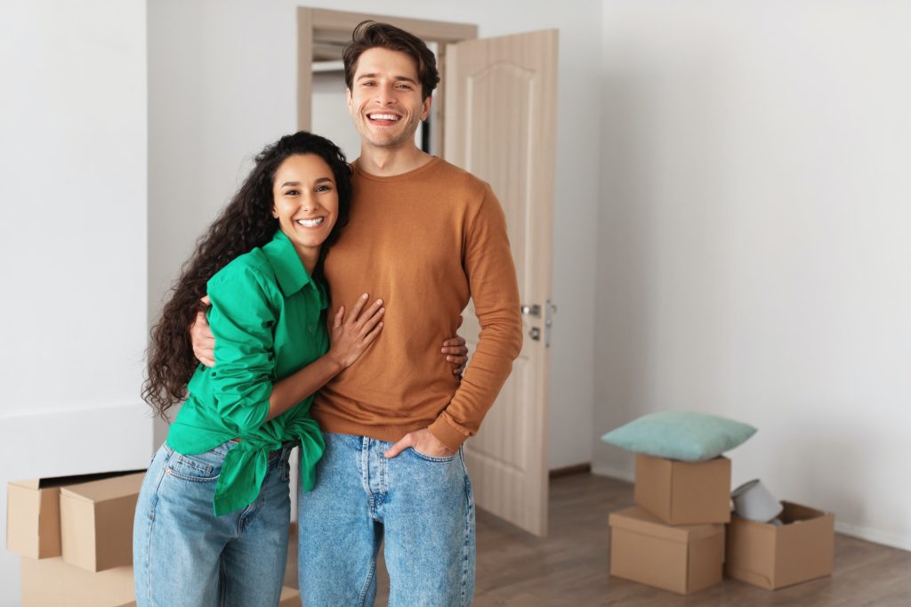 Happy man and woman posing on moving day