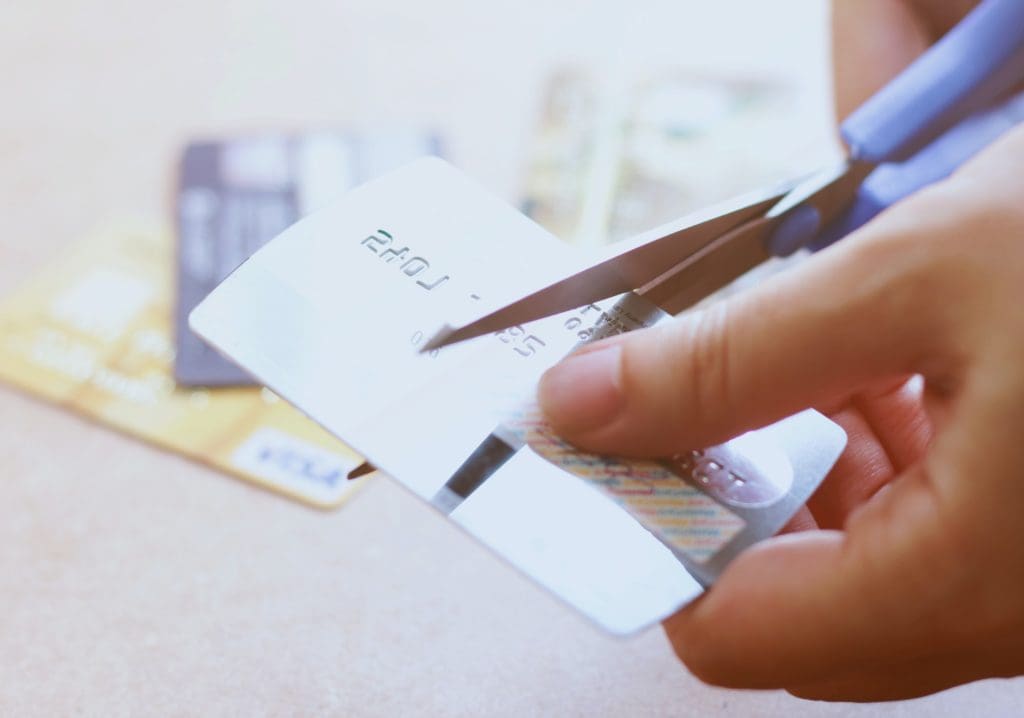 Hand cutting credit card with scissors