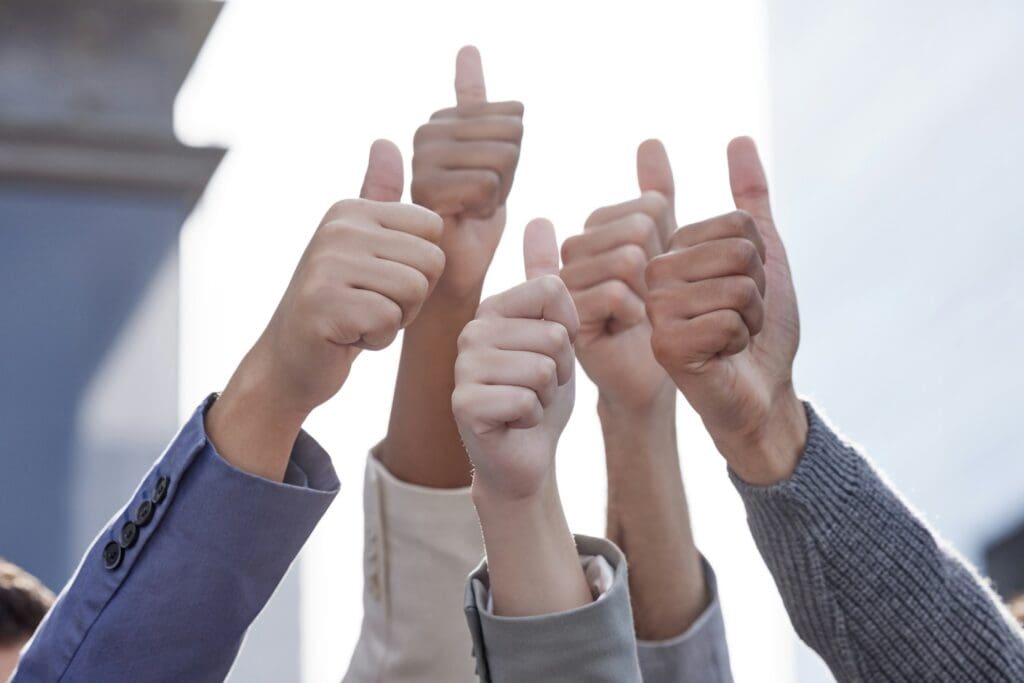 Taking it to the next level. Shot of a group of unrecognizable businesspeople showing a thumbs up.