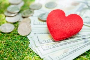 Love heart with coin money for financial health care and lover together concept.