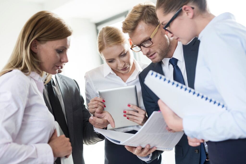 Business people reading in booklet
